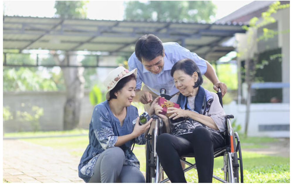 MobiCare companion and family with senior in wheelchair